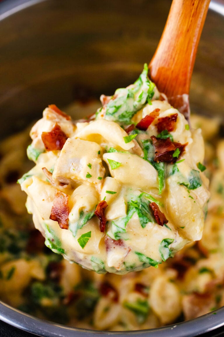 A ladle of creamy instant pot chicken bacon ranch pasta shells.