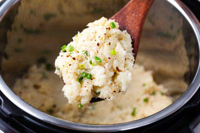 A large spoonful of Instant Pot mashed cauliflower.