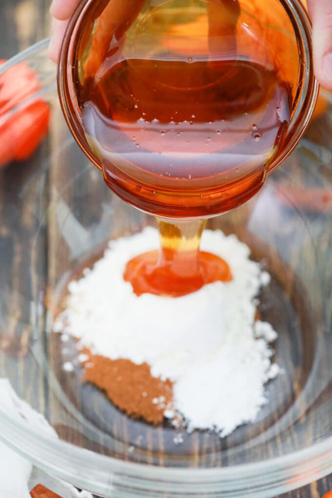 Adding maple syrup to a bowl of cornstarch.