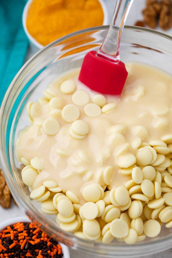 White chocolate chips and condensed milk in a bowl.