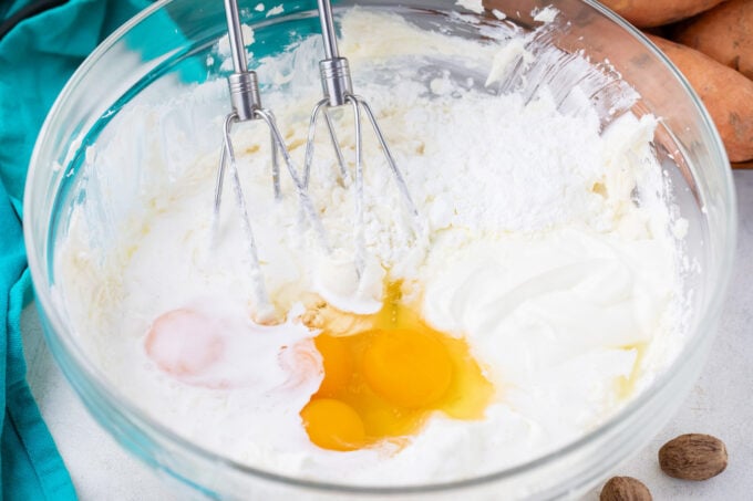 Whipping cheesecake batter in a bowl.