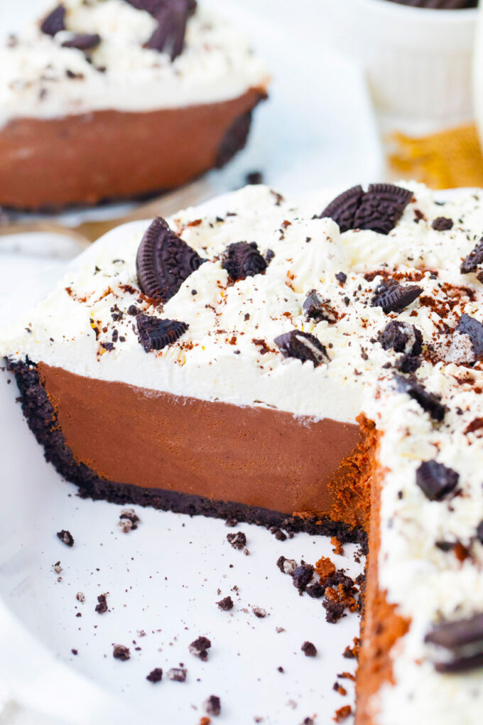 Homemade no bake chocolate pie topped with whipped cream and Oreo crumbs.