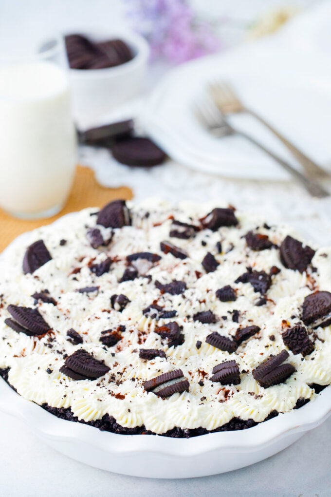 No bake chocolate pie topped with whipped cream and Oreos.