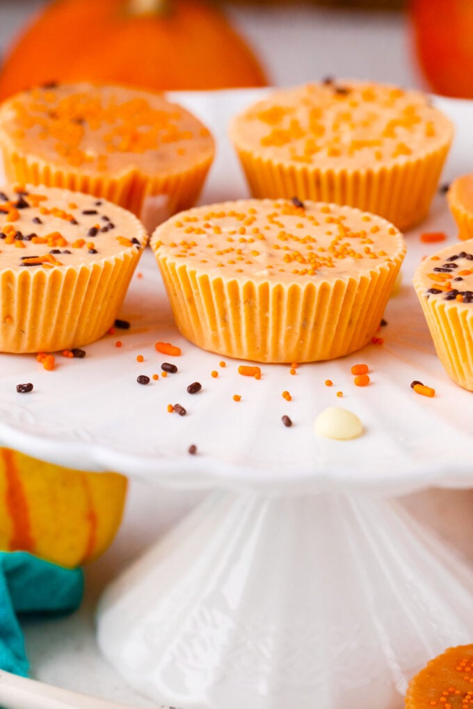 Orange pumpkin fudge on a cake stand.