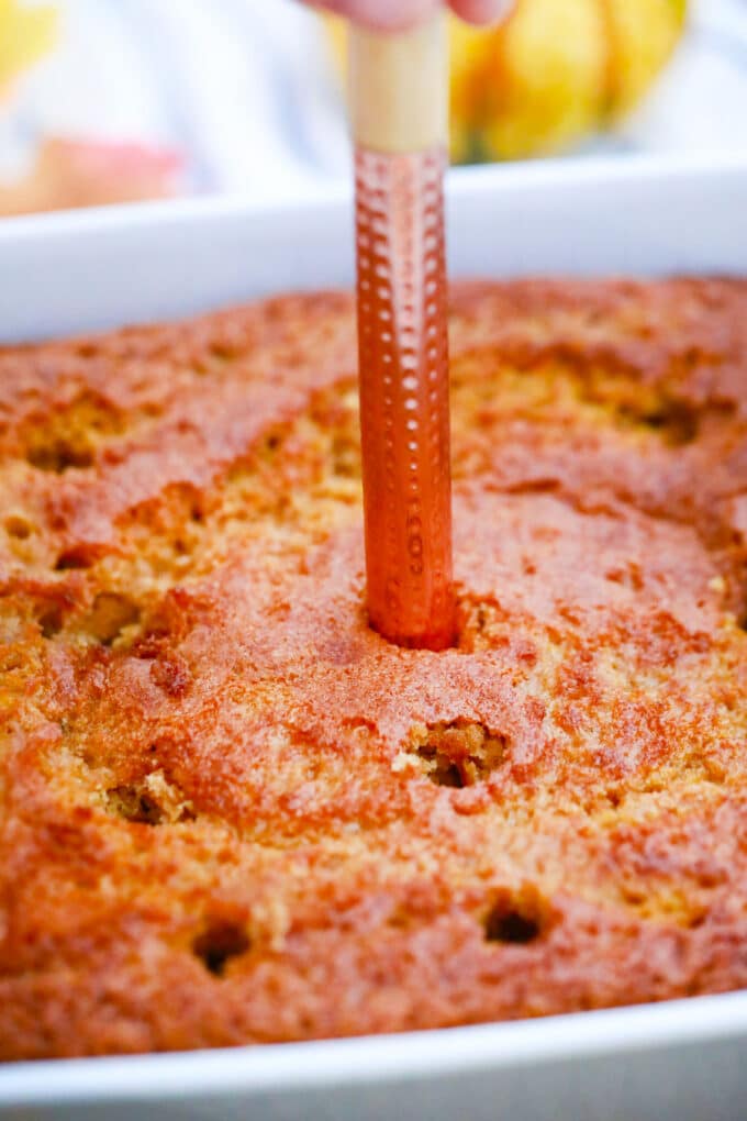 Poking a pumpkin cake.