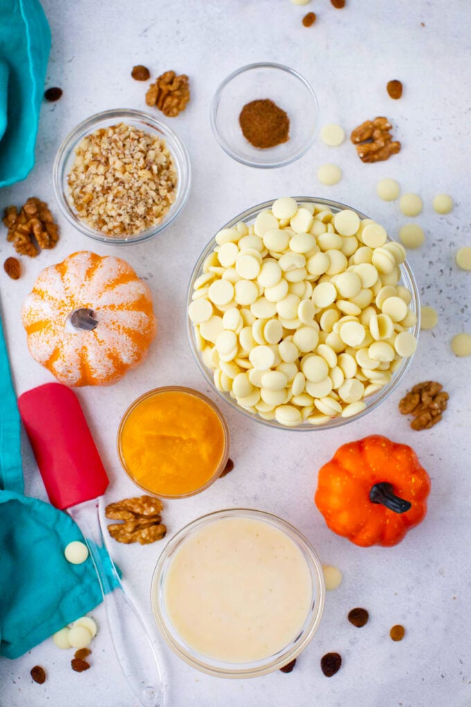 Overhead shot of pumpkin fudge ingredients in bowls on a table.
