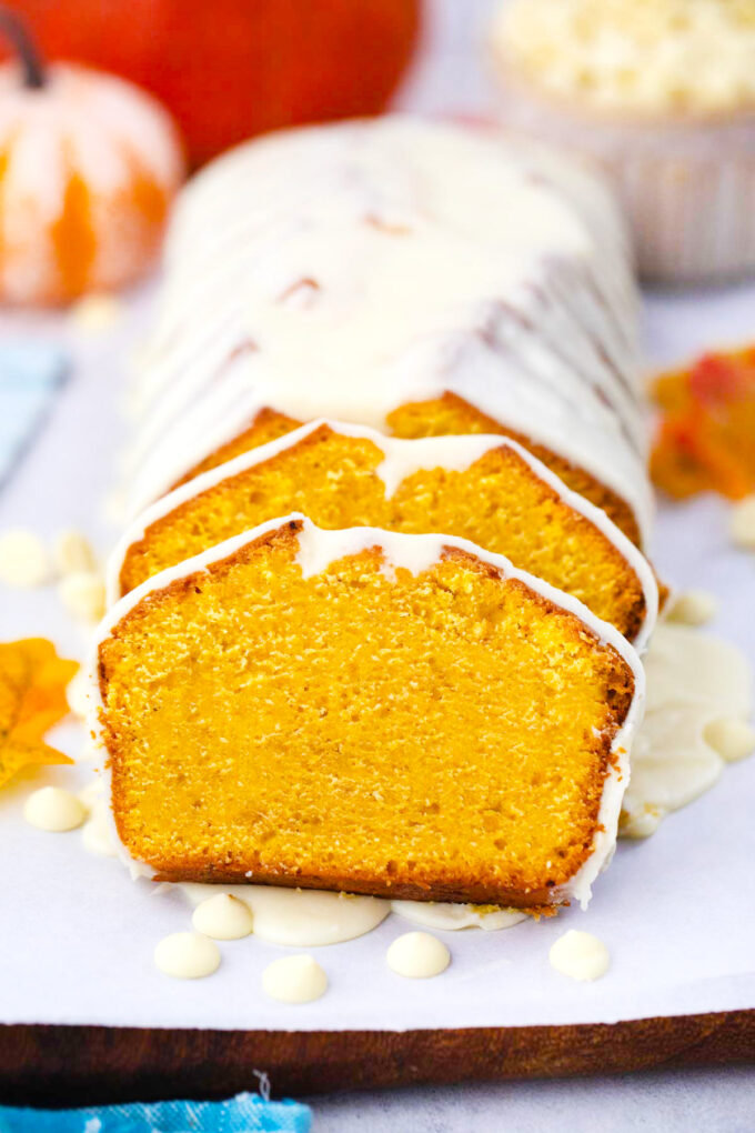Sliced pumpkin pound cake with white chocolate ganache.