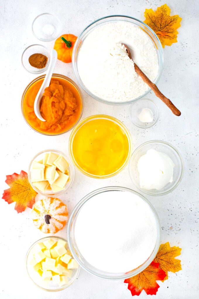Overhead shot of pumpkin pound cake ingredients in bowls on a table.