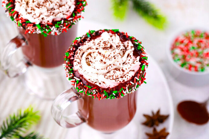Two cups of homemade red velvet hot chocolate topped with whipped cream.