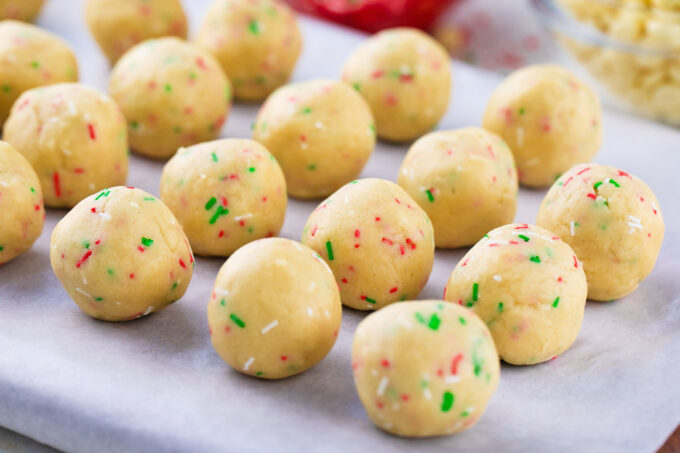 Sugar cookie truffles on parchment paper.