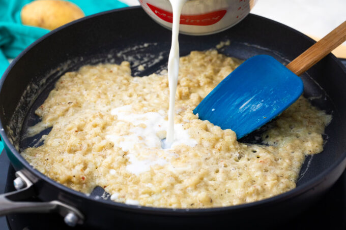 Adding milk to flour roux.