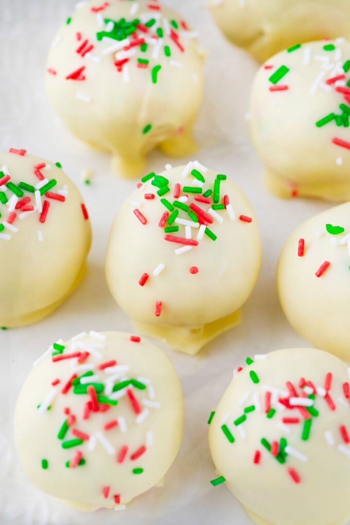 White chocolate sugar cookie truffles with red and green sprinkles.