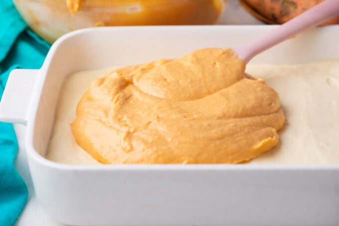 Spreading the sweet potato cheesecake layer.