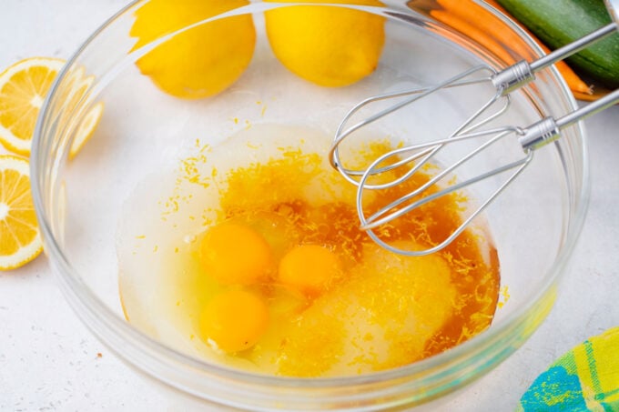 Whisking wet ingredients for carrot zucchini bread.