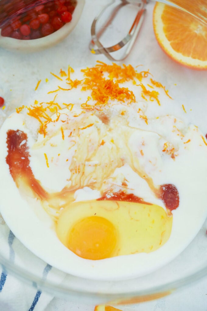 Stirring wet ingredients for cranberry orange bread.