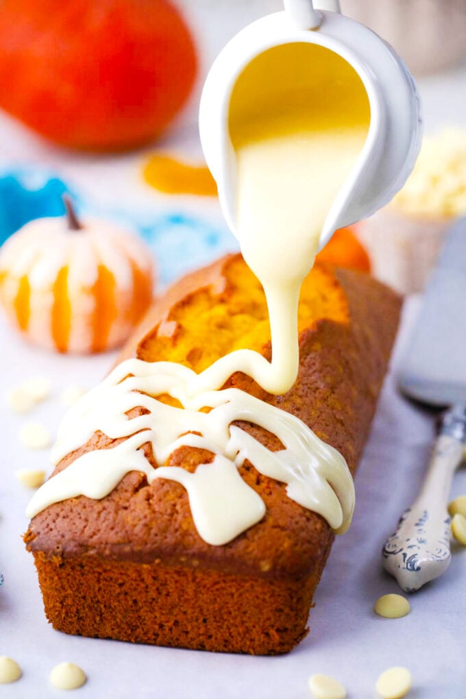 Drizzling white chocolate ganache on top of pumpkin pound cake.