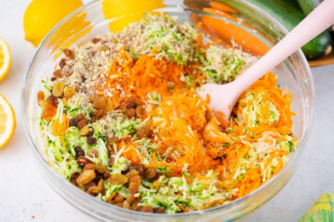 Stirring grated zucchini and carrots.
