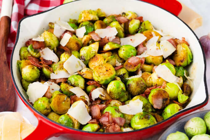 A pan of Brussels sprouts with bacon and parmesan cheese.