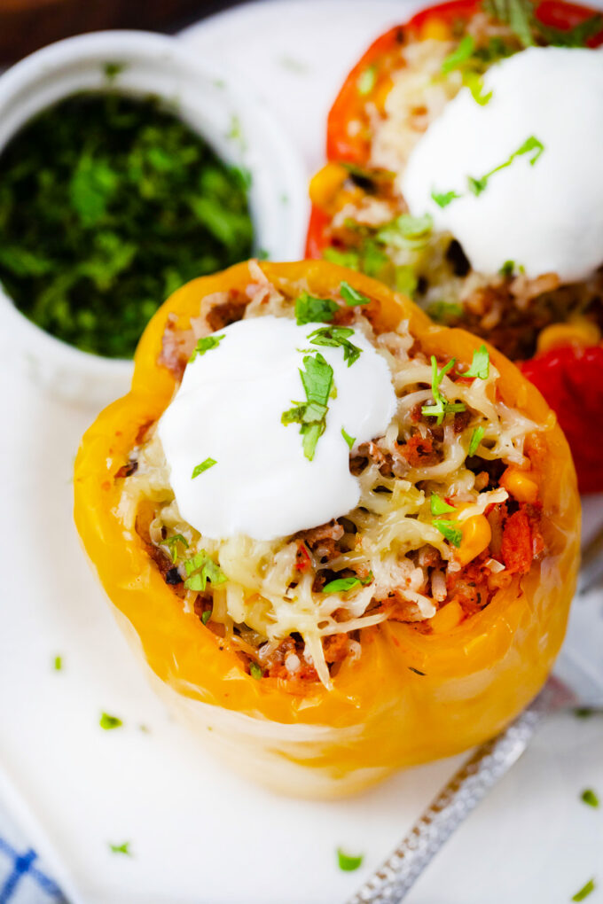 Slow cooker Mexican stuffed peppers topped with sour cream.