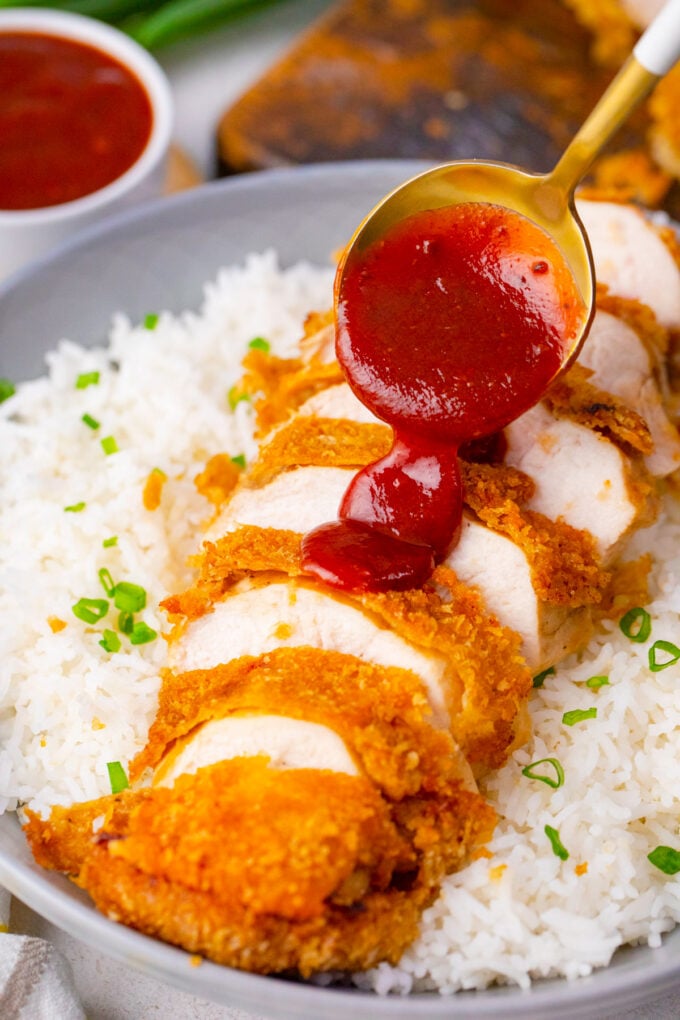 Drizzling tonkatsu sauce over crispy chicken katsu.