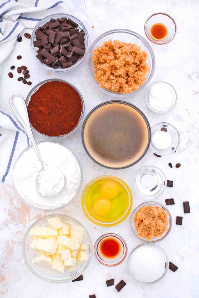 overhead shot of chocolate chips sugar eggs chocolate butter flour on a table