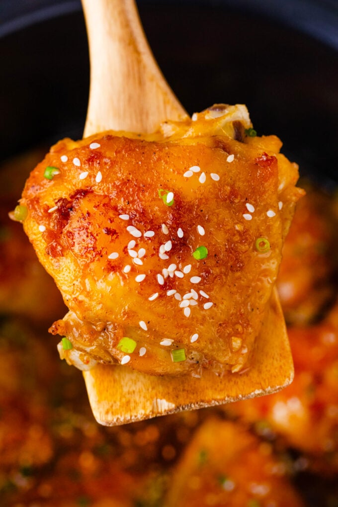 Crockpot brown sugar garlic chicken thigh on a serving spatul.