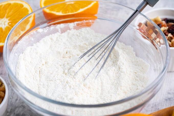 Whisking dry ingredients in a bowl.