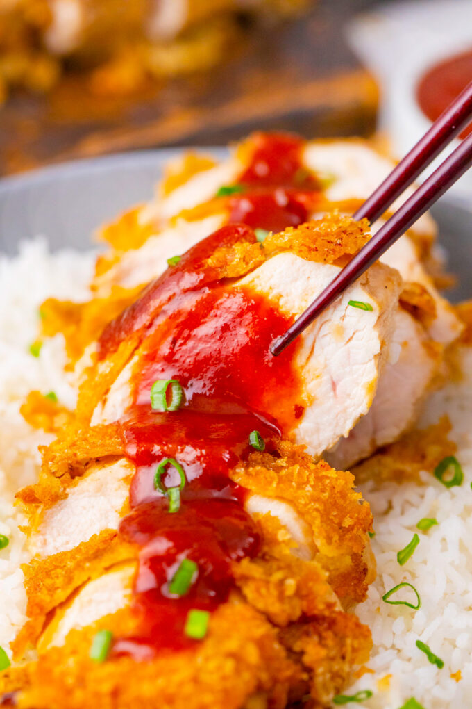 Close shot of chicken katsu with tonkatsu sauce.