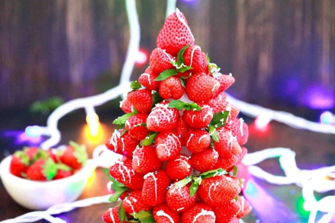 strawberry christmas tree with christmas lights in the background