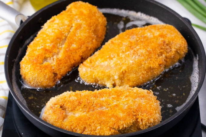 Super crispy chicken katsu in a cast iron pan.