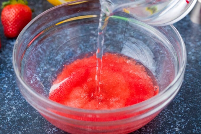 Preparing strawberry Jell-o.