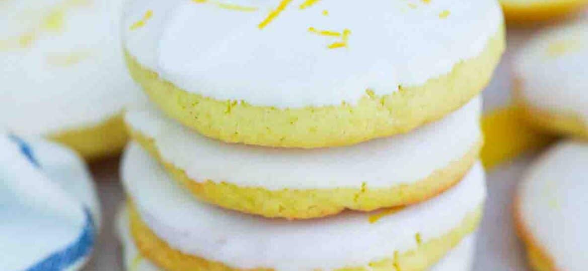 stacked homemade girl scout lemon cookies with lemon in the background