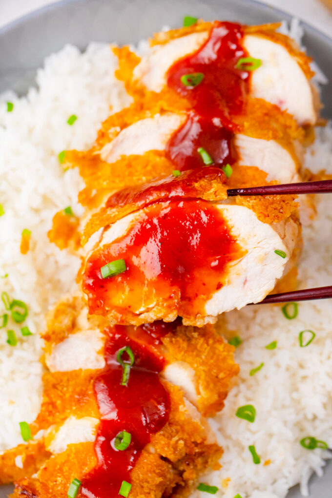 Homemade chicken katsu with tonkatsu sauce over white rice.