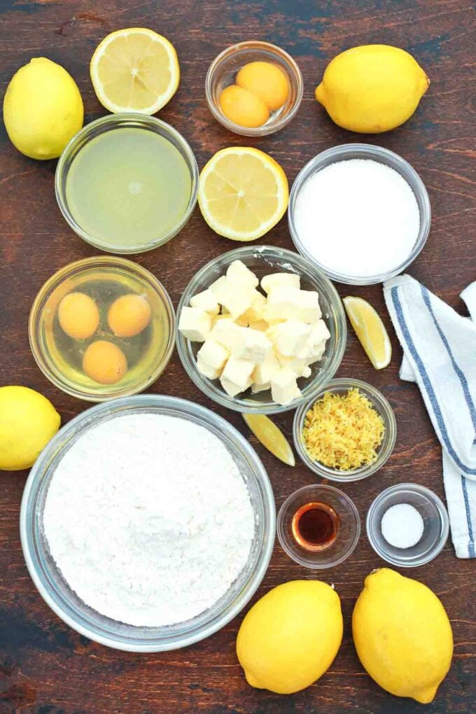 overhead shot of butter sugar lemon eggs lemon juice in bowls on a table