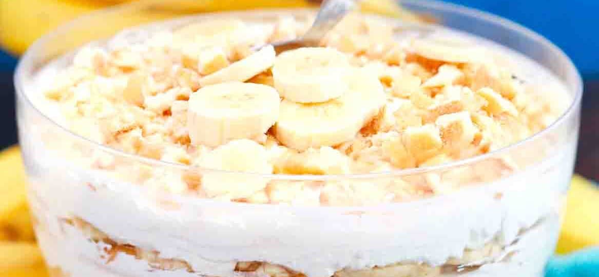 a bowl of homemade magnolia bakery banana pudding with bananas in the background