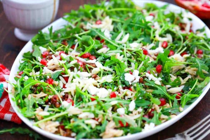 a platter of pomegranate orzo salad