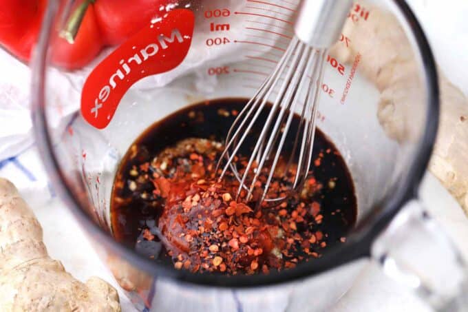 Hunan sauce ingredients being whisked in a measuring cup.