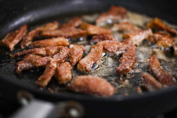 Searing flank steak pieces.