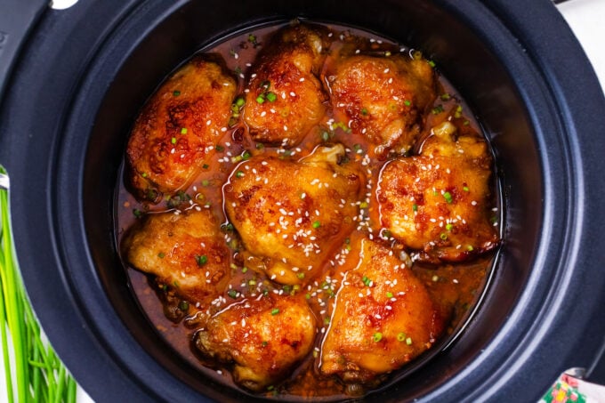 Slow cooker brown sugar garlic chicken topped with green onions and sesame seeds.