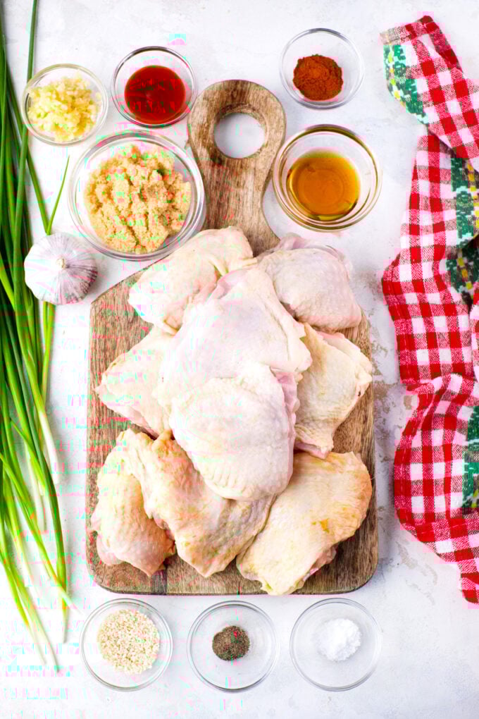 Overhead shot of slow cooker brown sugar garlic chicken ingredients arranged on a table.