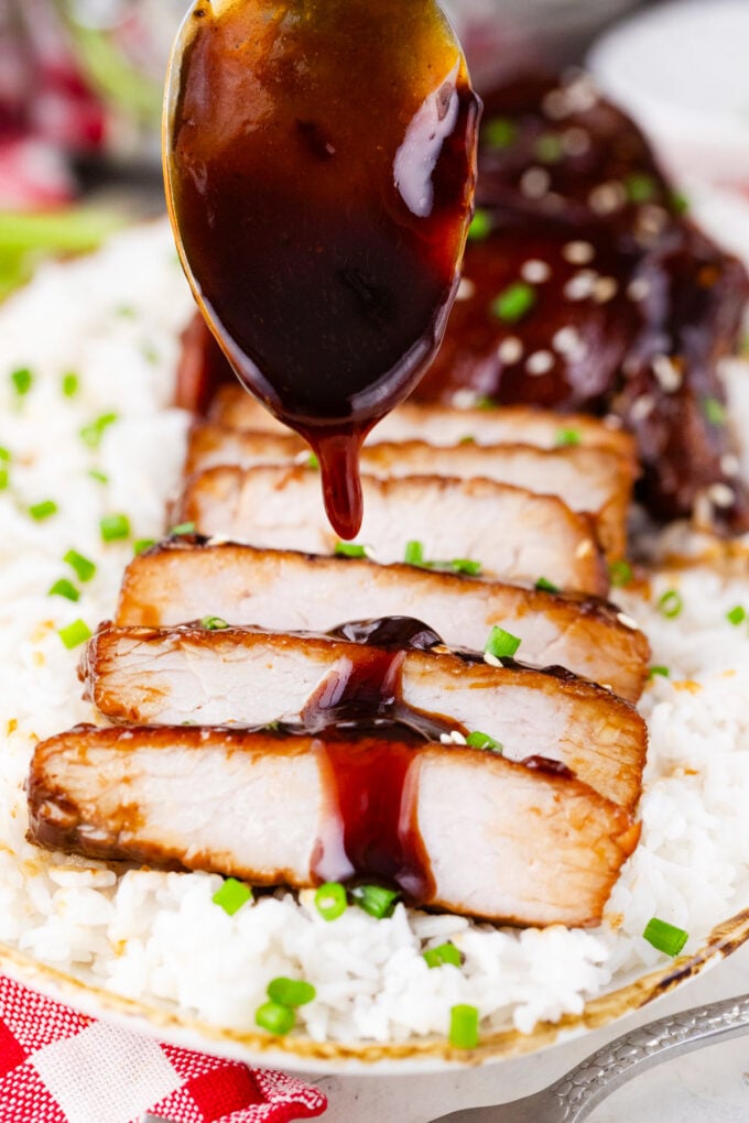 Drizzling pork chops with teriyaki sauce.