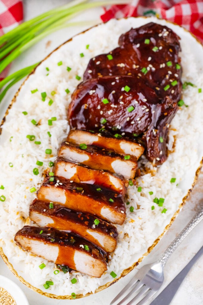 Sliced slow cooker pork chops with teriyaki sauce.