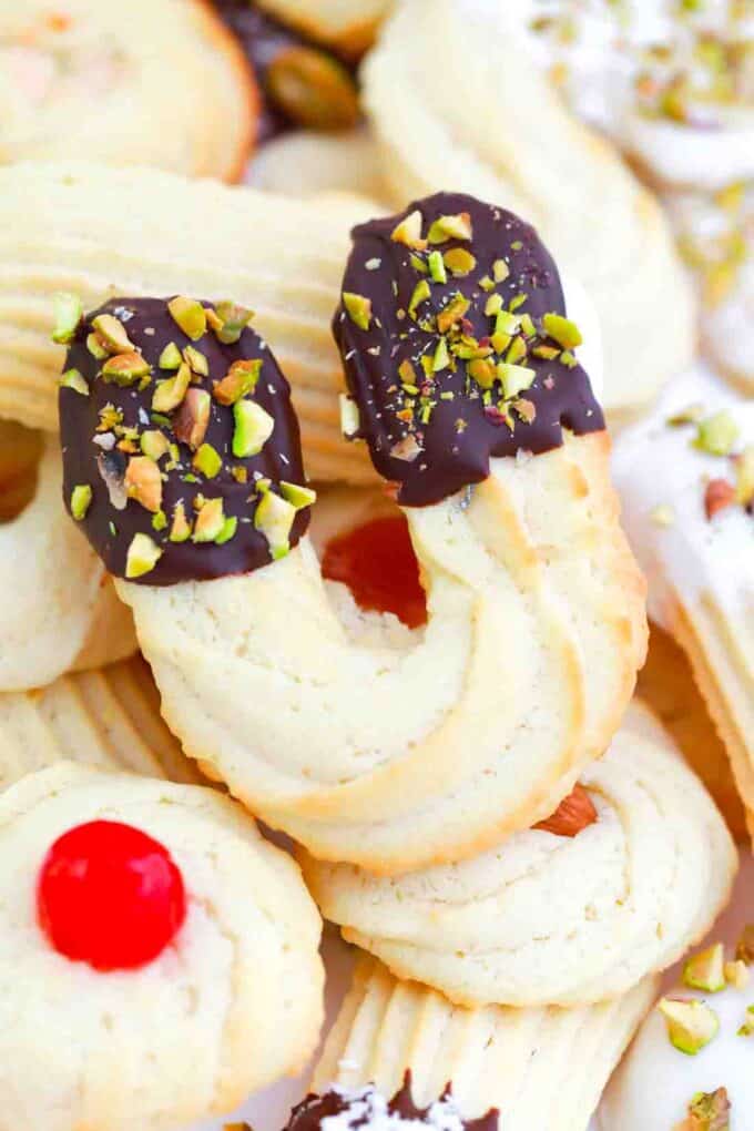 traditional italian butter cookies dipped in chocolate and topped with pistachios