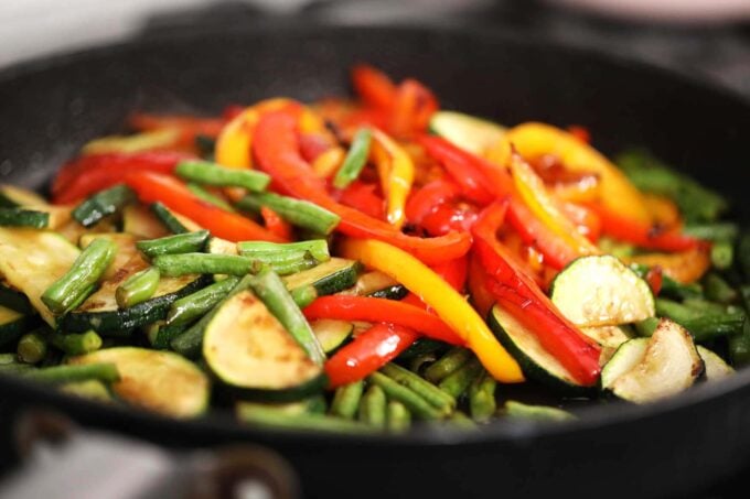 Sautéing veggies in a pan.