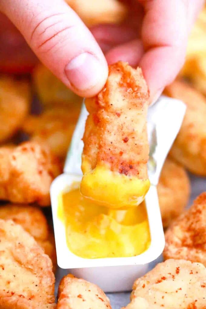 dipping McDonalds chicken nuggets in honey mustard sauce