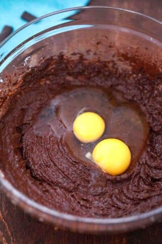 adding eggs to chocolate batter