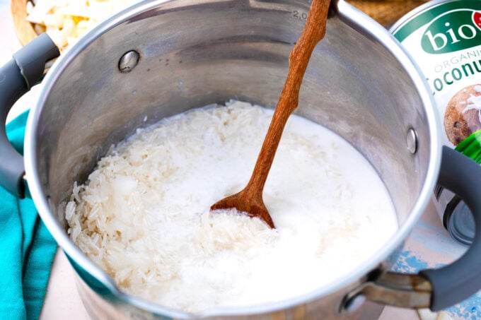 Stirring ingredients for coconut rice in a sauce pan.