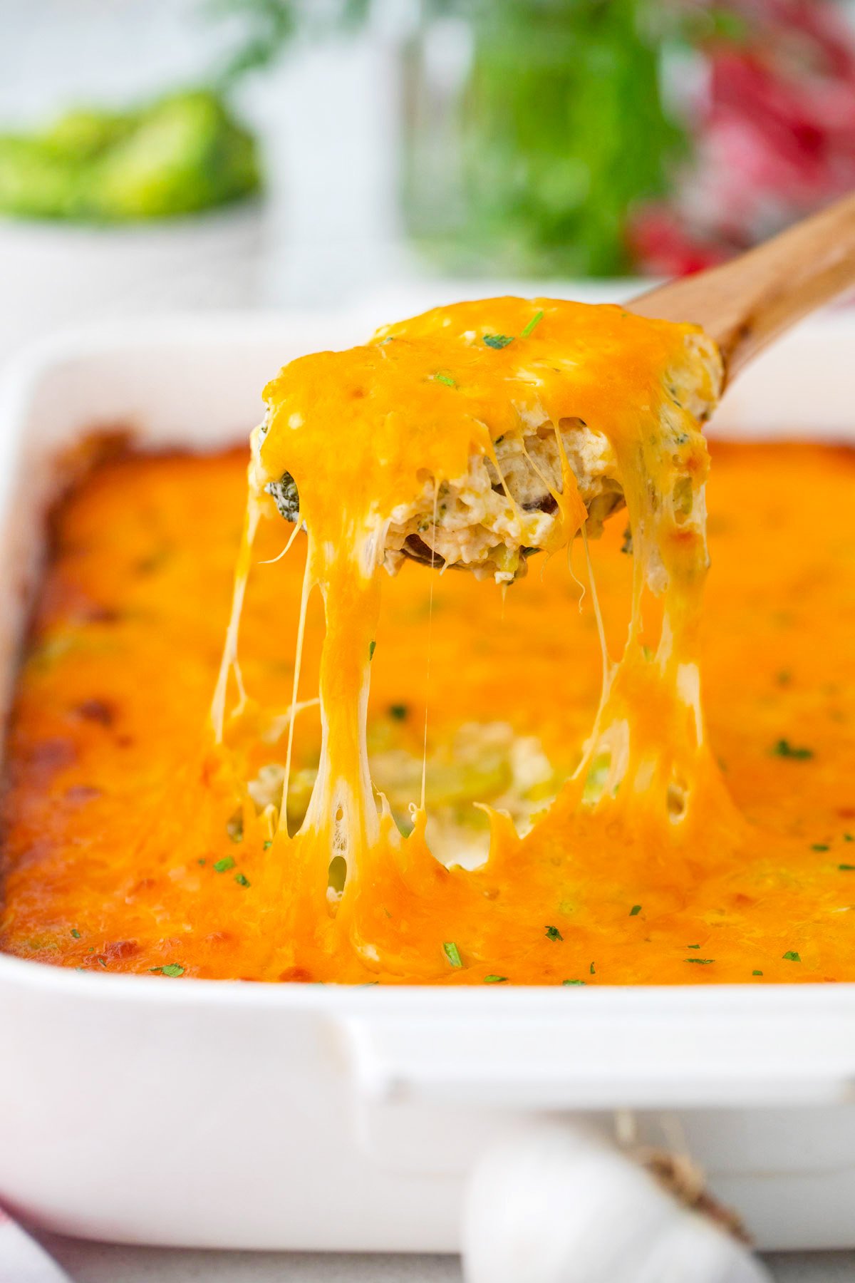 A spoonful of very cheesy broccoli rice casserole.