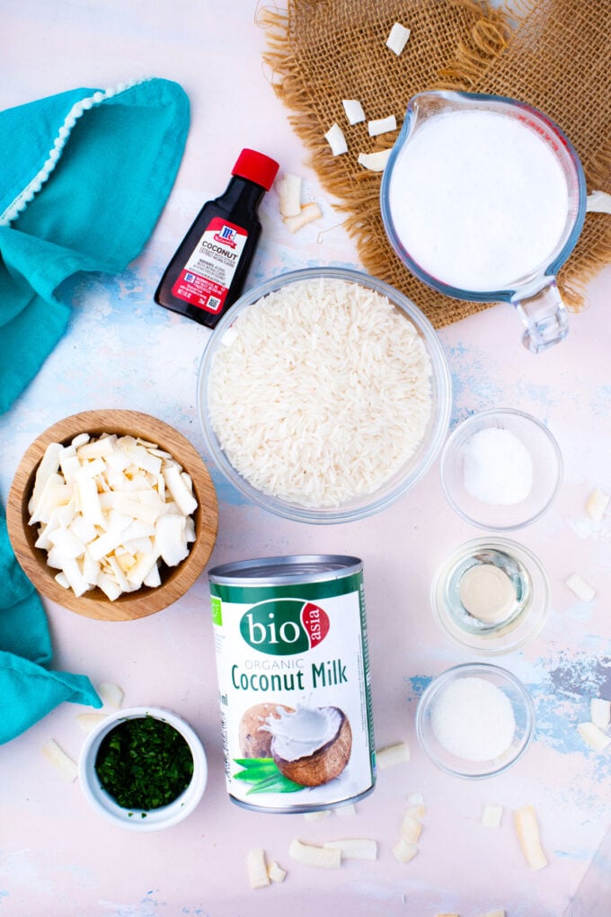 Overhead shot of coconut rice ingredients in bowls on a table.