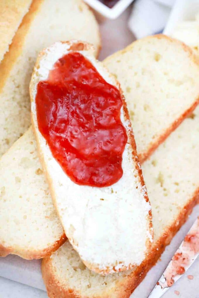 overhead shot of white crockpot bread served with butter and jam